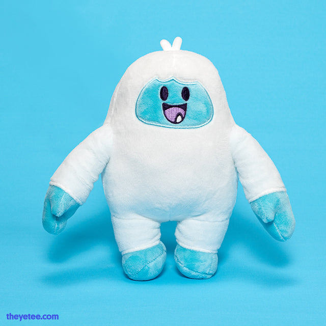 A white Yetee with light blue feet and hands. Smiling adorably with two tufts of hair on top of its head.  - Yetee Plush 2.0
