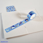 Roll of decorative tape with cartoon designs on a grid surface, with 'theyeteecom' branding. - Amaro Memo Stationery Set