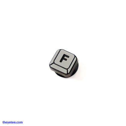 Grey keyboard keycap of the letter F.