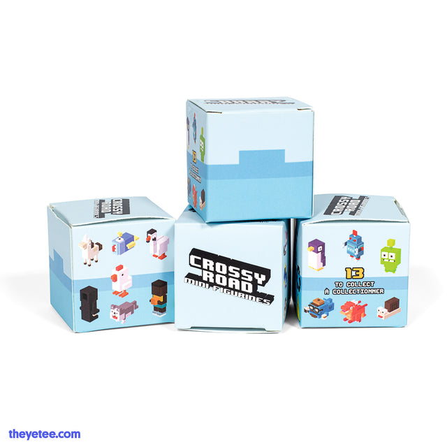 A small box color-blocked with three shade of blue from lightest to darkest. Along sides are photos of the collectables.  - Crossy Road Minifigure Mystery 4-Pack