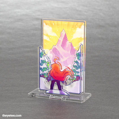  Trekking through snow, a winter valley of trees opens up in front of Madeline as she faces off with the massive mountain. 