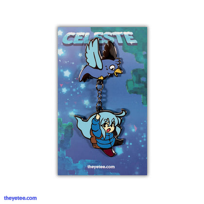 Hard enamel pin of blue bird flying holding chain with Madeline hanging from end