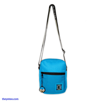 Blue field bag with Energy Tank logo and silicon Mega Man zipper pull. Straps are black with white kanji text. 