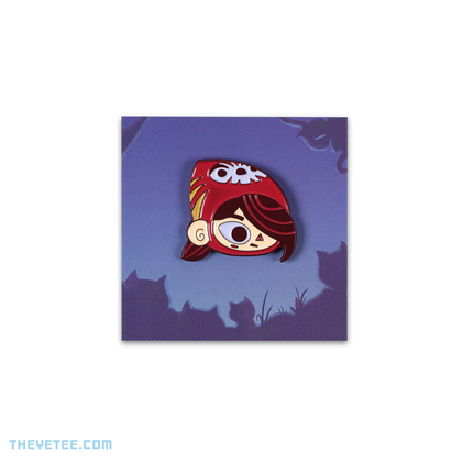 Soft enamel pin of Mineko's head while wearing a red hat and looking to the right.