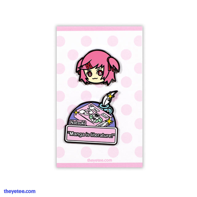 Pin of Natsuki's head wearing red crossed hairclip and two side ponytails. 2nd pin is manga captioned "Manga is literature!" - Natsuki Pin Set