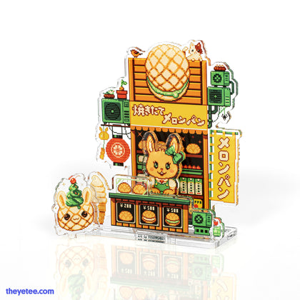 Yellow bunny wearing green bow works a yellow food stall with bunny shaped wind chime, big ice cream cone and baked breads. 