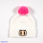 White winter knit hat has embroidered Bomberman face. Hot pink pom pom on top - Bomberman Winter Cap