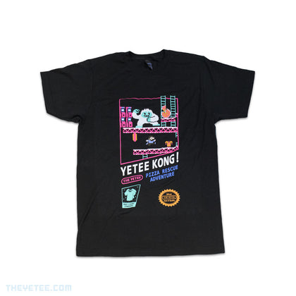Black tee shirt with pixelated design centered on chest. In a retro construction site, protagonist must dash and jump across platforms while steering clear of the Yetee to rescue their beloved pizza.
